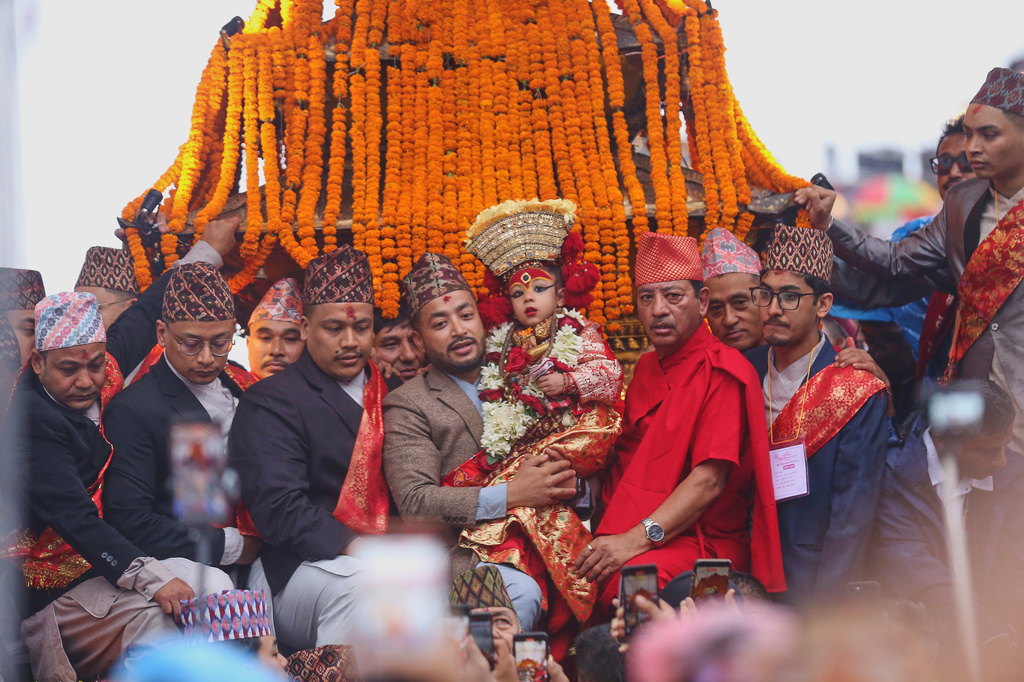 Living goddess Kumari reacts as she is being carried during Indra Jatra, a festival that marks the end of the rainy season in Kathmandu, Nepal, Friday, Sept. 25, 2026. (AP Photo/Subash Shrestha)
