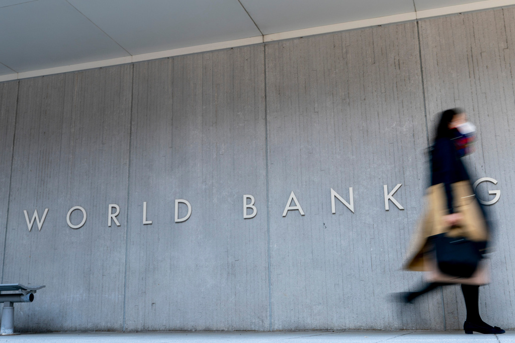 FILE - A woman walks past the World Bank building in Washington on April 5, 2021. (AP Photo/Andrew Harnik, File)PRNTO