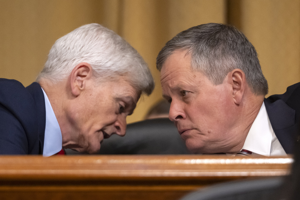 Sen. Bill Cassidy, R-La., left, talks with Sen. Steve Daines, R-Mont., as Secretary of Health and Human Services Robert F. Kennedy Jr., appears before the Senate Finance Committee, on Capitol Hill in Washington, Thursday, Sept. 4, 2025. (AP Photo/Mark Schiefelbein)