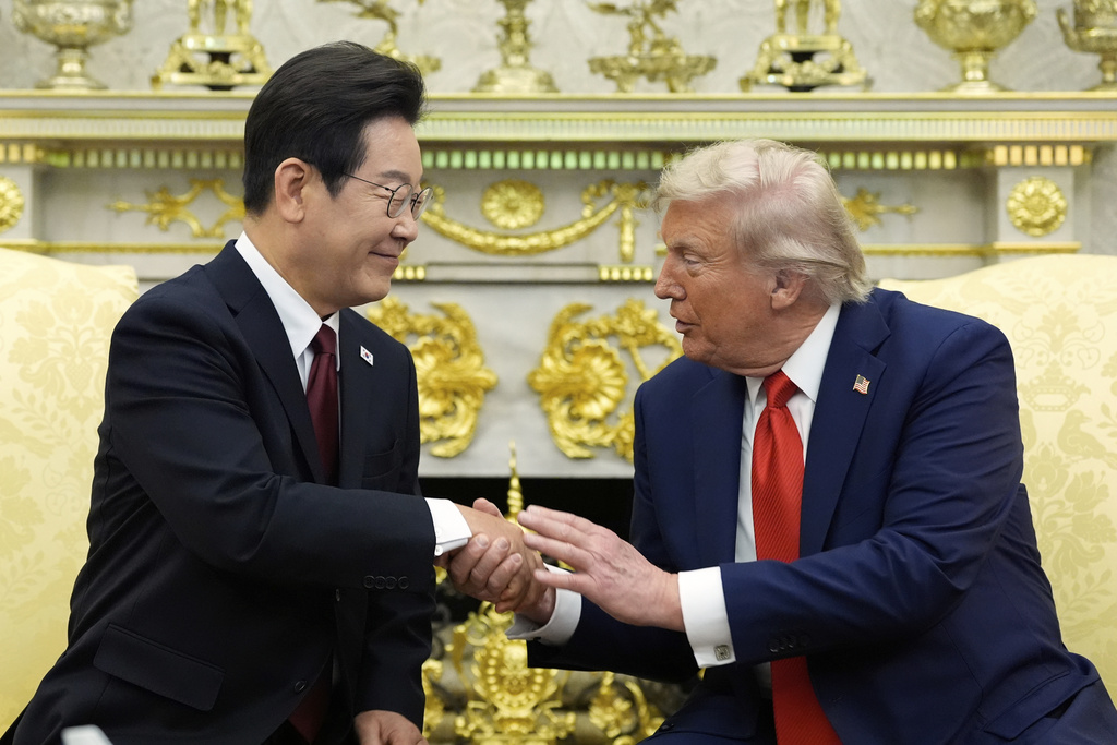 President Donald Trump, right, shakes the hand of South Korean President Lee Jae Myung during a meeting in the Oval Office of the White House, Monday, Aug. 25, 2025, in Washington. (AP Photo/Alex Brandon)