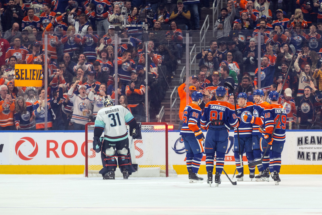 Seattle Kraken goalie Philipp Grubauer (31) looks on as the Edmonton Oilers celebrate a goal during first period NHL action, in Edmonton on Tuesday, March 31, 2026. (Jason Franson/The Canadian Press via AP)