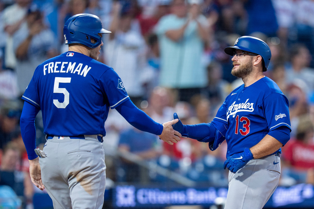 Los Angeles Dodgers' Max Muncy, right, celebrates his two-run home run with Freddie Freeman, left, during the sixth inning of a baseball game against the Philadelphia Phillies, Wednesday, July 22, 2026, in Philadelphia. (AP Photo/Chris Szagola)