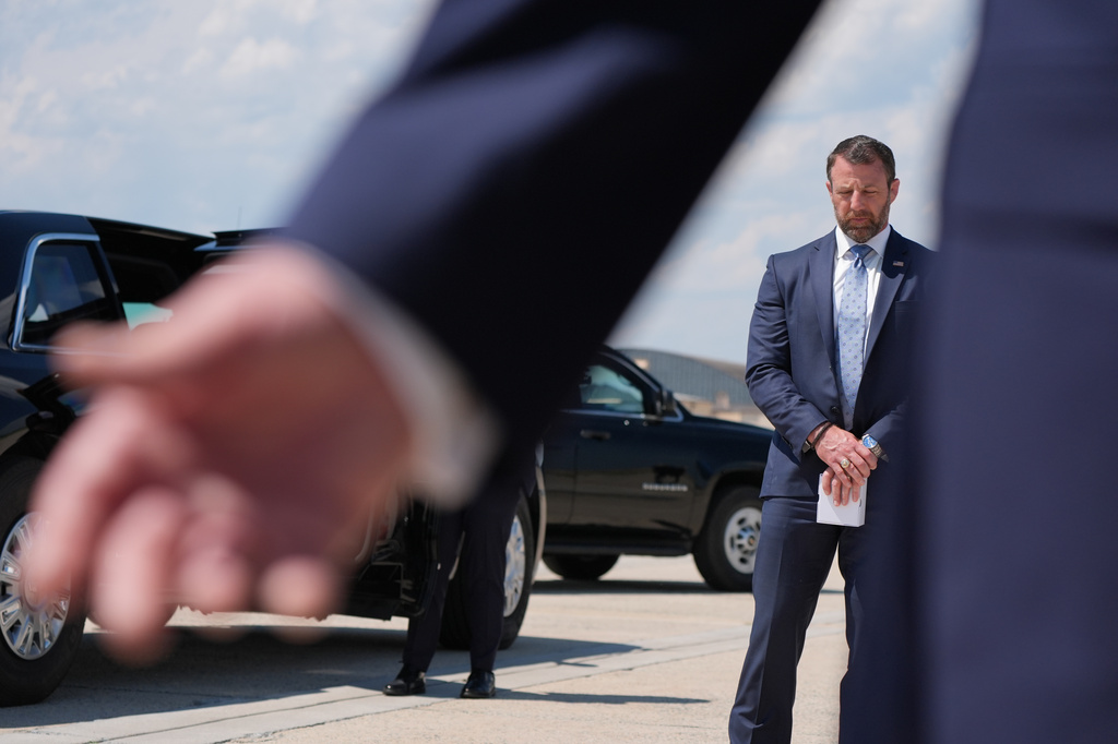 Homeland Security Secretary Markwayne Mullin, listens as President Donald Trump speaks to the press after returning and stepping off Air Force One, Wednesday, May 20, 2026, at Joint Base Andrews, Md. (AP Photo/Jacquelyn Martin)