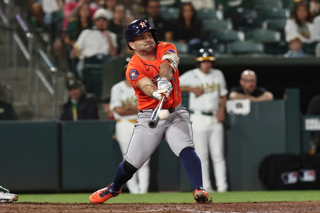 Houston Astros' Jose Altuve hits a sacrifice fly during the eighth inning of a baseball game against the Athletics Friday, Sept. 25, 2026, in West Sacramento, Calif. (AP Photo/Sara Nevis)
