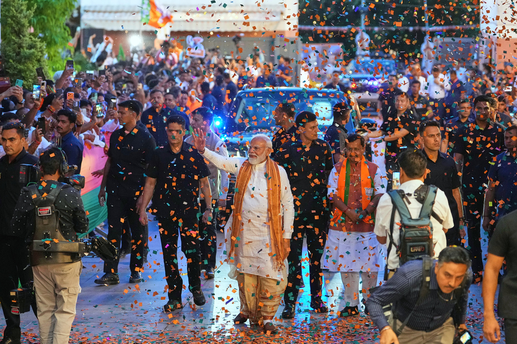 Confetti is sprayed as Indian Prime Minister Narendra Modi, center, waves to supporters upon his arrival at the Bharatiya Janata Party (BJP) headquarters to celebrate victory in the recently held state assembly elections in New Delhi, India, Monday, May 4, 2026. (AP Photo/Manish Swarup)