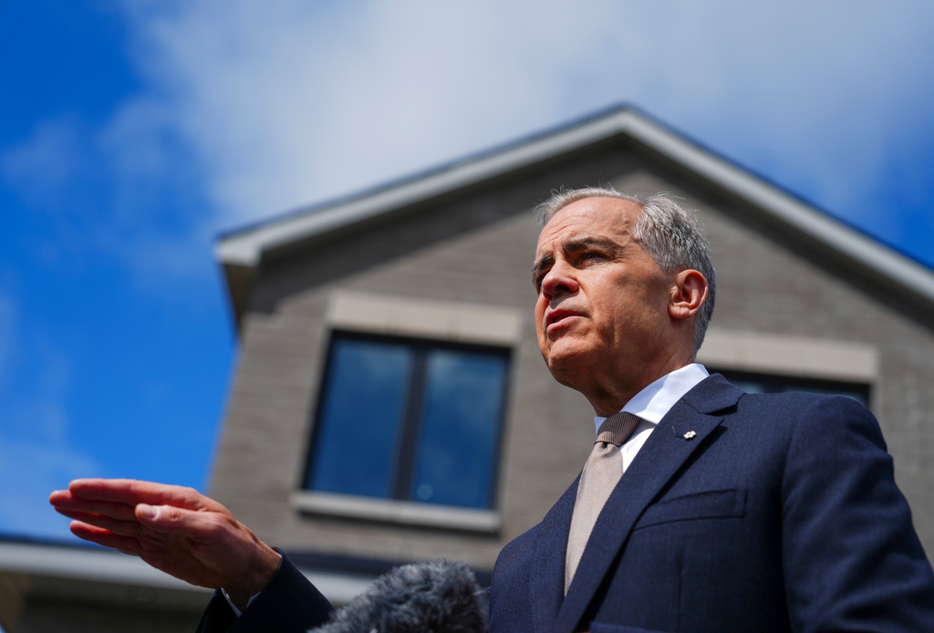 Prime Minister Mark Carney talks to reporters as he takes part in an event at a new housing development in Orleans, Ont., on Monday, May 25, 2026. (Sean Kilpatrick /The Canadian Press via AP)