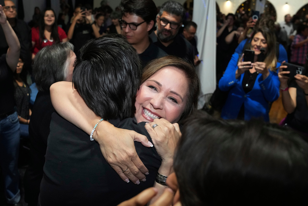 Arizona Democratic candidate Adelita Grijalva, center right, smiles as she is hugged by her family after being declared the winner against Republican Daniel Butierez to fill the Congressional District 7 seat held by the late U.S. Rep. Raúl Grijalva in a special election Tuesday, Sept. 23, 2025, in Tucson, Ariz. (AP Photo/Ross D. Franklin)
