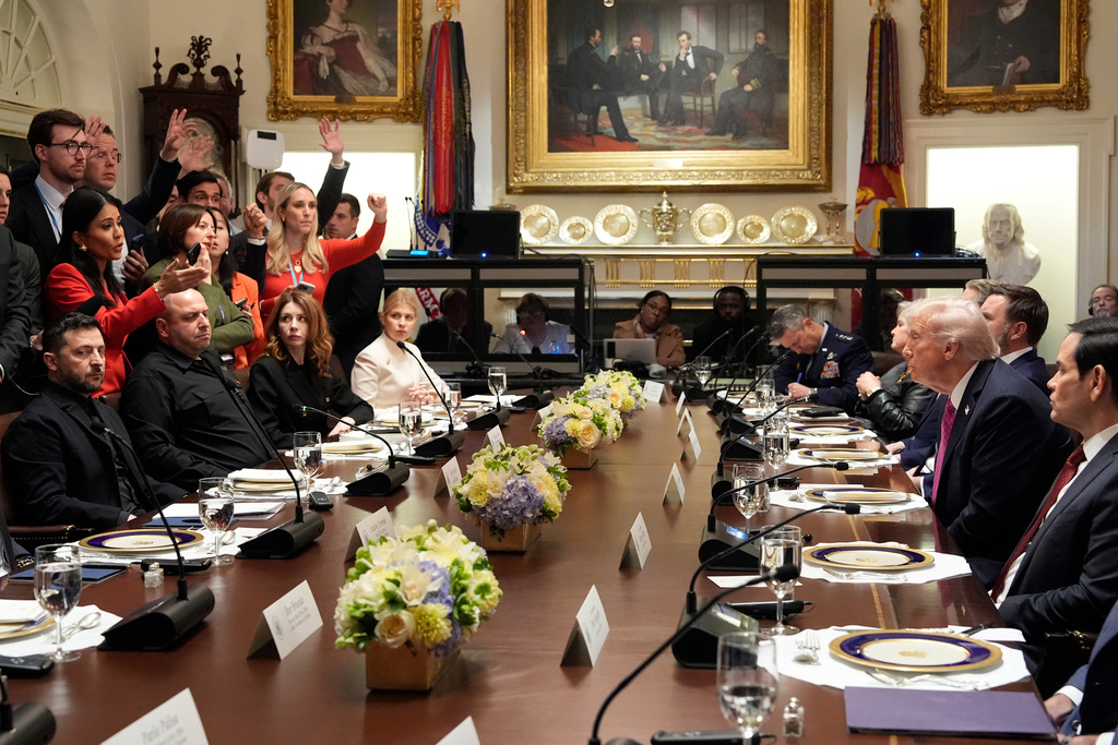 President Donald Trump, second right, and Ukraine's President Volodymyr Zelenskyy, seated left, sit as reporters ask questions before a lunch in the Cabinet Room of the White House, Friday, Oct. 17, 2025, in Washington. (AP Photo/Alex Brandon)