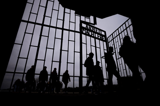 FILE - People walk through the gate with the inscription "Arbeit Macht Frei" of the Nazi concentration camp Sachsenhausen in Oranienburg, Germany, April 18, 2023. (AP Photo/Markus Schreiber, File) FILE - People walk through the gate with the inscription "Arbeit Macht Frei" of the Nazi concentration camp Sachsenhausen in Oranienburg, Germany, April 18, 2023. (AP Photo/Markus Schreiber, File)