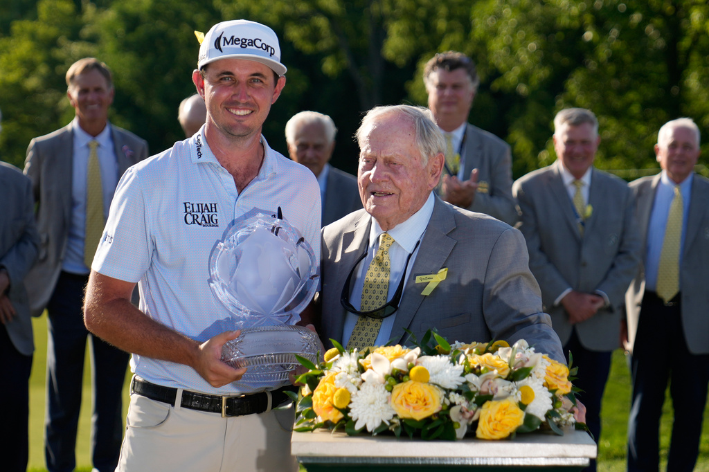 J.T. Poston poses with the trophy and Jack Nicklaus after winning the Memorial golf tournament, Sunday, June 7, 2026, in Dublin, Ohio. (AP Photo/Sue Ogrocki)