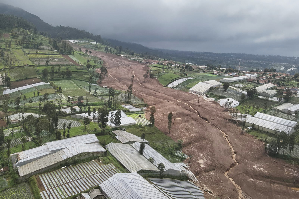In this photo released by the Indonesian National Search and Rescue Agency (BASARNAS), an aerial shot taken using a drone shows an area affected by landslides in Pasir Langu village, in West Bandung district of West Java province, Indonesia, Saturday, Jan. 24, 2026. (BASARNAS via AP)