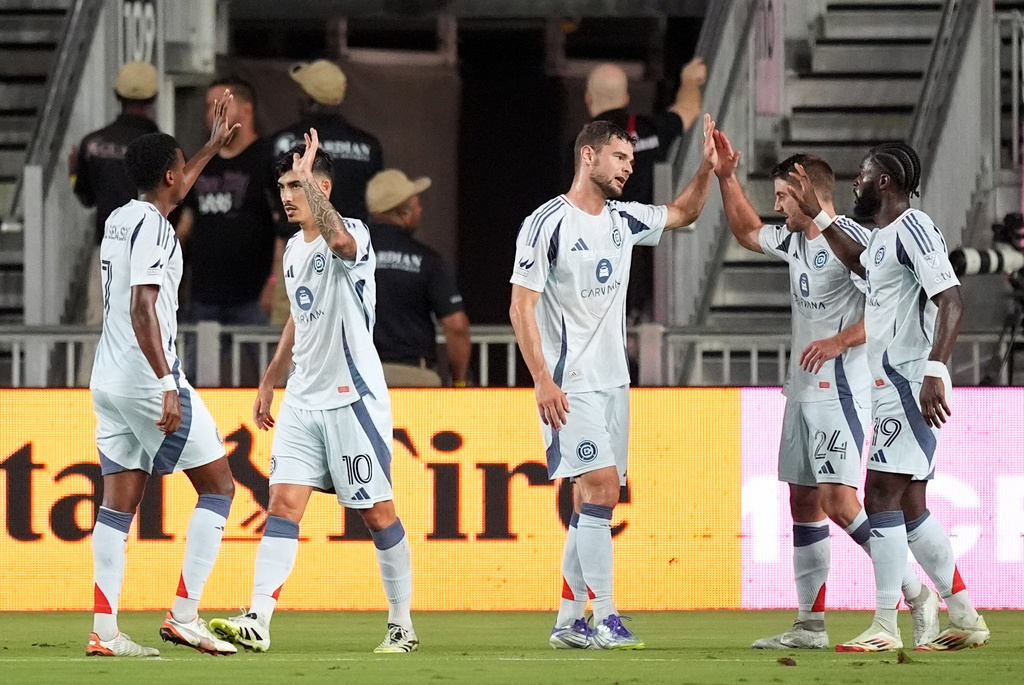 Teammates celebrate with Chicago Fire defender Jonathan Dean (24) after he scored their side's second goal against Inter Miami during the first half of an MLS soccer match, Tuesday, Sept. 30, 2025, in Fort Lauderdale, Fla. (AP Photo/Rebecca Blackwell)