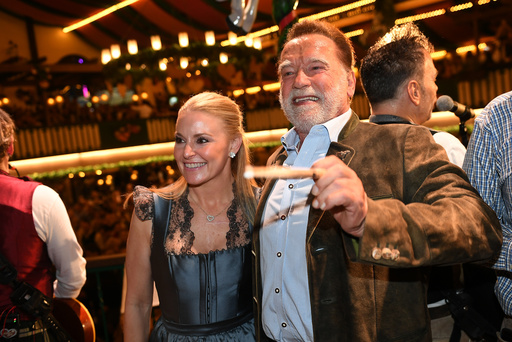 Arnold Schwarzenegger and his partner, Heather Milligan stand on stage during the 190th Oktoberfest on Friday, Sept. 26, 2025, in Munich, Germany. (Felix Hörhager/dpa via AP) Arnold Schwarzenegger and his partner, Heather Milligan stand on stage during the 190th Oktoberfest on Friday, Sept. 26, 2025, in Munich, Germany. (Felix Hörhager/dpa via AP)