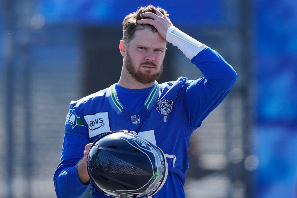 Seattle Seahawks quarterback Sam Darnold (14) arrives during an NFL Super Bowl football practice on Friday, Feb. 6, 2026, in San Jose, Calif., ahead of Super Bowl 60 between the New England Patriots and the Seattle Seahawks. (AP Photo/Brynn Anderson)