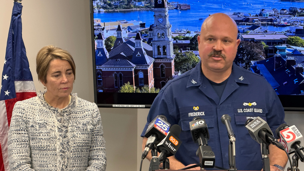 U.S. Coast Guard, Sector Boston, Captain of the Port and Commander Jamie Frederick, right, speaks during a news conference about the commercial fishing vessel, the Lily Jean, that sank off Gloucester, as Massachusetts Gov. Maura Healey listens, Wednesday, Feb. 18, 2026 in Gloucester, Mass. (AP Photo/Rodrique Ngowi)