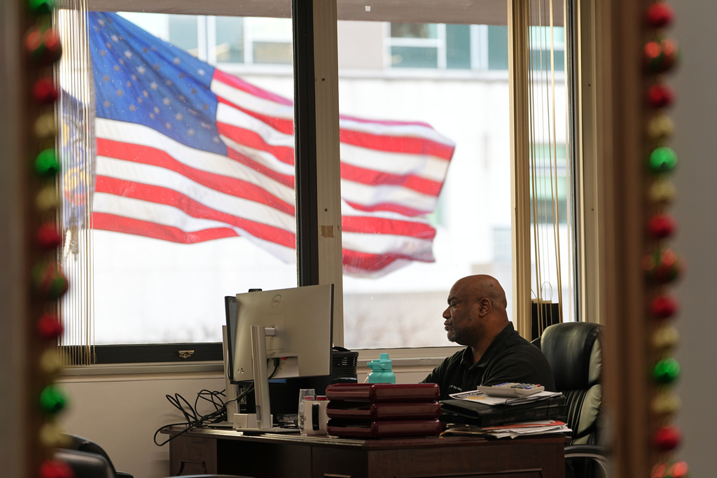 Ahmad Collins works at his office in Harrisburg, Pa., Thursday, Dec. 11, 2025. A city government worker and former Penn State linebacker, Collins has needed 10 hours a night of dialysis since a medical procedure left him with damaged kidneys late last year. . (AP Photo/Matt Rourke)