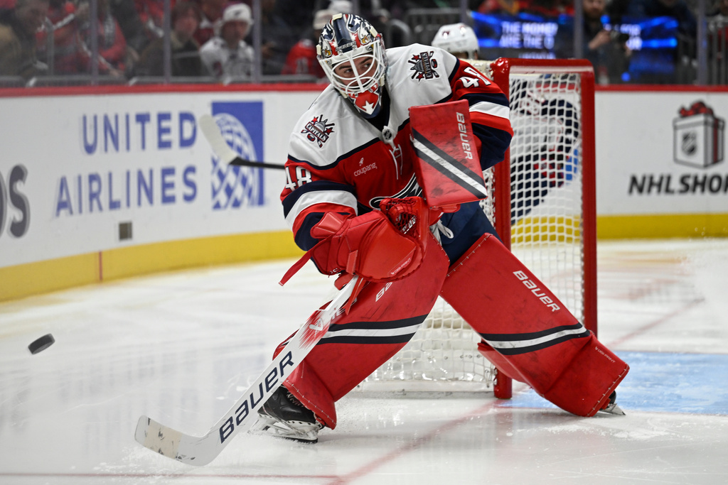 Washington Capitals goaltender Logan Thompson clears the puck during the second period of an NHL hockey game against the Columbus Blue Jackets, Sunday, Dec. 7, 2025, in Washington. (AP Photo/John McDonnell)