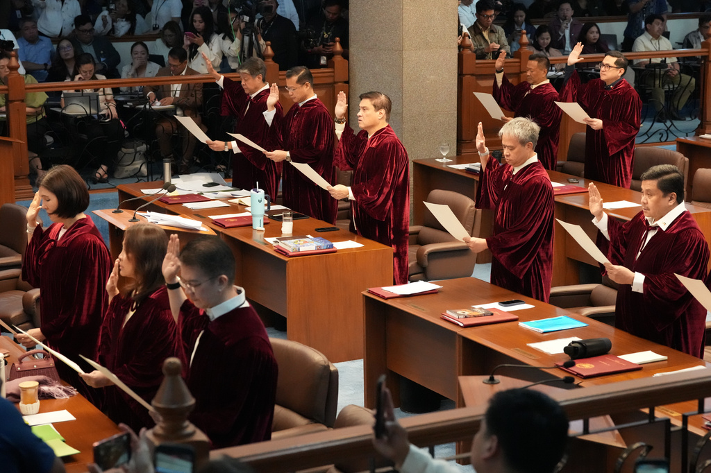 Philippine senators take oath as they convene as an impeachment court for the trial of Vice President Sara Duterte at the Philippine senate, Monday, May 18, 2026, in Pasay, Philippines. (AP Photo/Aaron Favila)