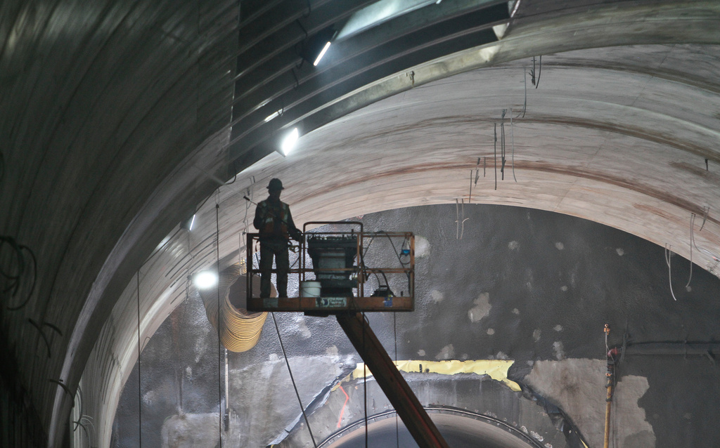 FILE - A construction worker is hoisted towards the ceiling inside the 86th Street cavern of the Second Avenue subway tunnel, May 1, 2014 in New York. (AP Photo/Bebeto Matthews, File)