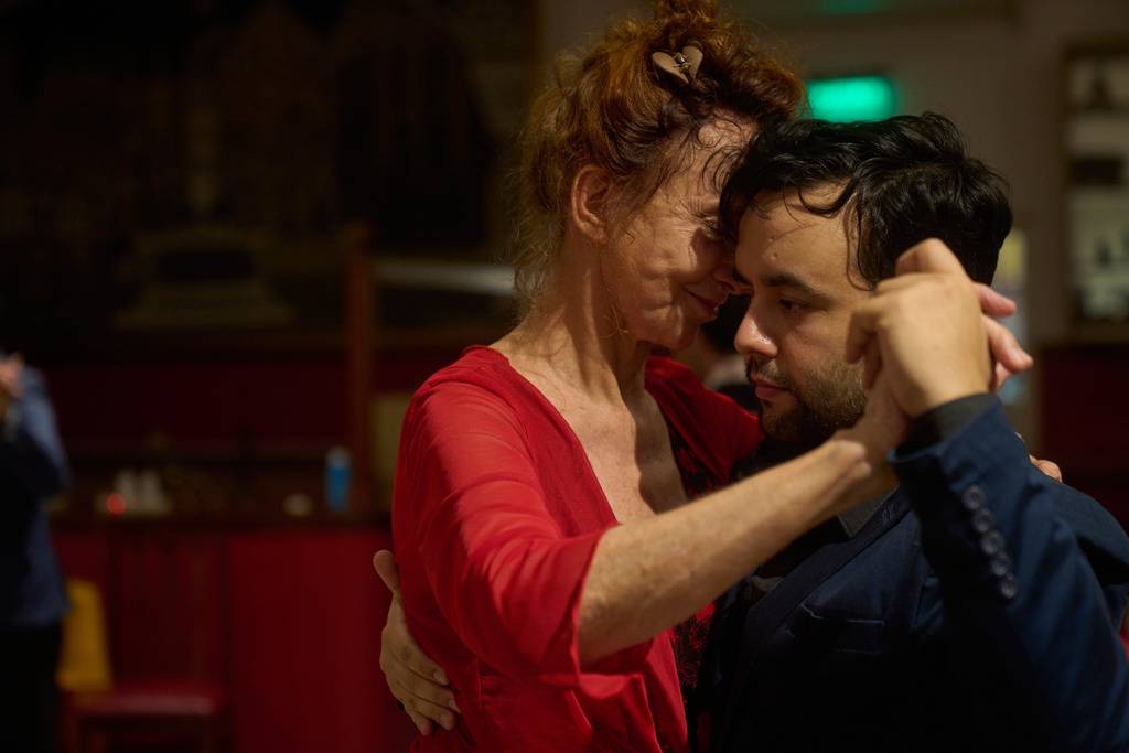 Antje Rickel, of France, left, dances with professional tango dancer Jared Ramos at the Che Che Tango Premium, where people can book guaranteed two‑hour dances with professional partners known as “Taxi Dancers," in Buenos Aires, Wednesday, Dec. 3, 2025. (AP Photo/Victor R. Caivano)