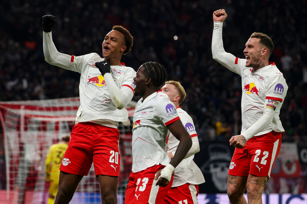 Leipzig's scorer Assan Ouedraogo, left, and and his teammates celebrate the opening goal during the German Bundesliga Soccer match between RB Leipzig and Werder Bremen in Leipzig, Germany, Sunday, Nov. 23, 2025. (Jan Woitas/dpa via AP)