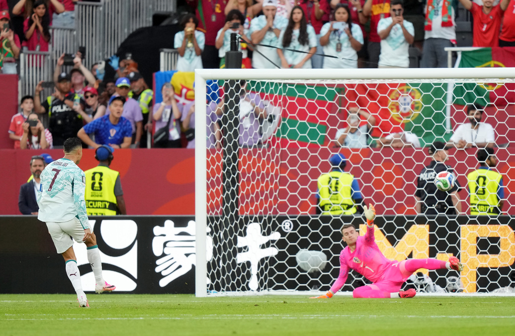 Portugal's Cristiano Ronaldo (7) scores on a penalty kick past Croatia goalkeeper Dominik Livakovic (1) during the World Cup round of 32 soccer match between Portugal and Croatia in Toronto, Thursday, July 2, 2026. (Nathan Denette/The Canadian Press via AP)