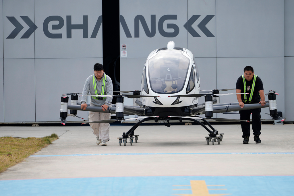 Workers prepare the EHang eVTOL EH126-S to fly in Guangzhou in southern China's Guangdong province on Monday, Nov. 3, 2025. (AP Photo/Ng Han Guan)