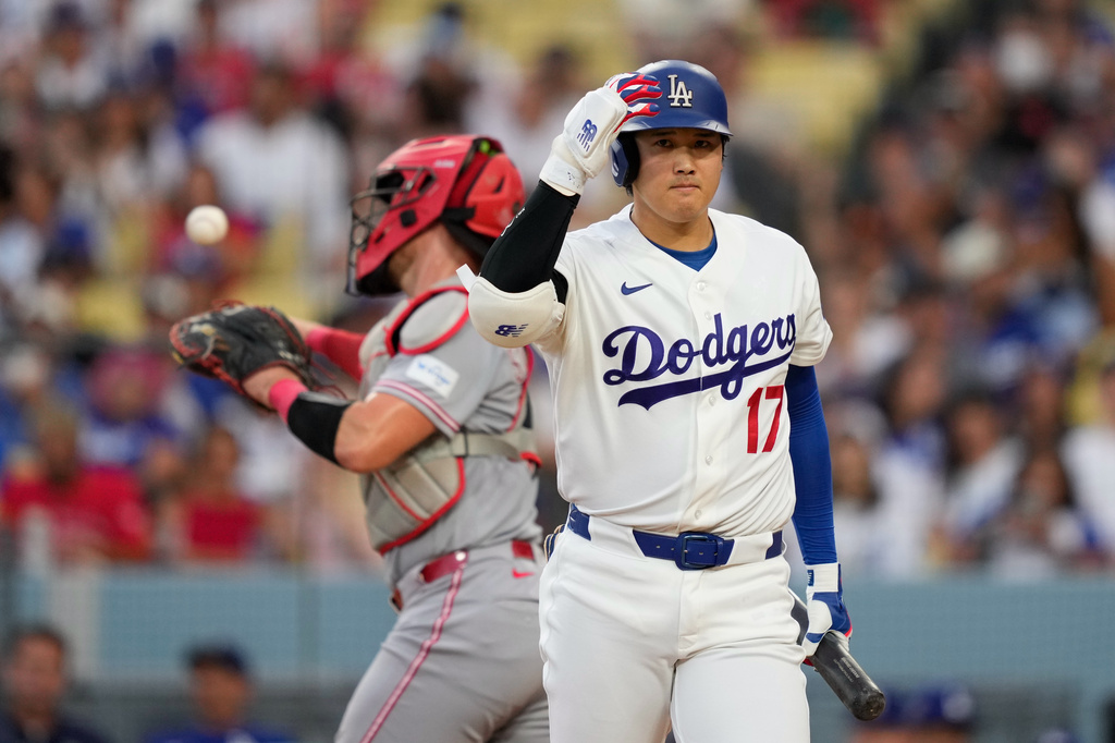 Los Angeles Dodgers' Shohei Ohtani, right, walks back to the dugout after striking out as Cincinnati Reds catcher Tyler Stephenson throws the ball back during the third inning of a baseball game Monday, Sept. 7, 2026, in Los Angeles. (AP Photo/Mark J. Terrill)