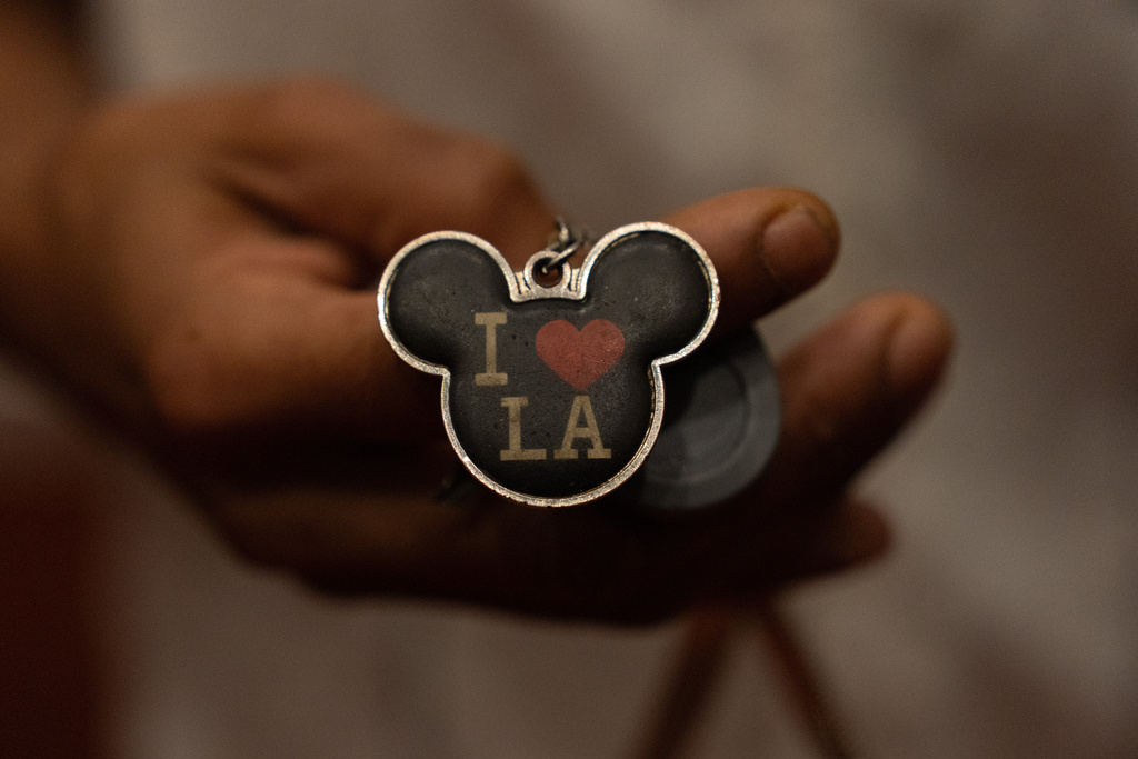 Quantavia Smith shows a keychain outside her studio apartment in the Santa Monica and Vermont Apartments complex in Los Angeles, Monday, Nov. 10, 2025. (AP Photo/Jae C. Hong)