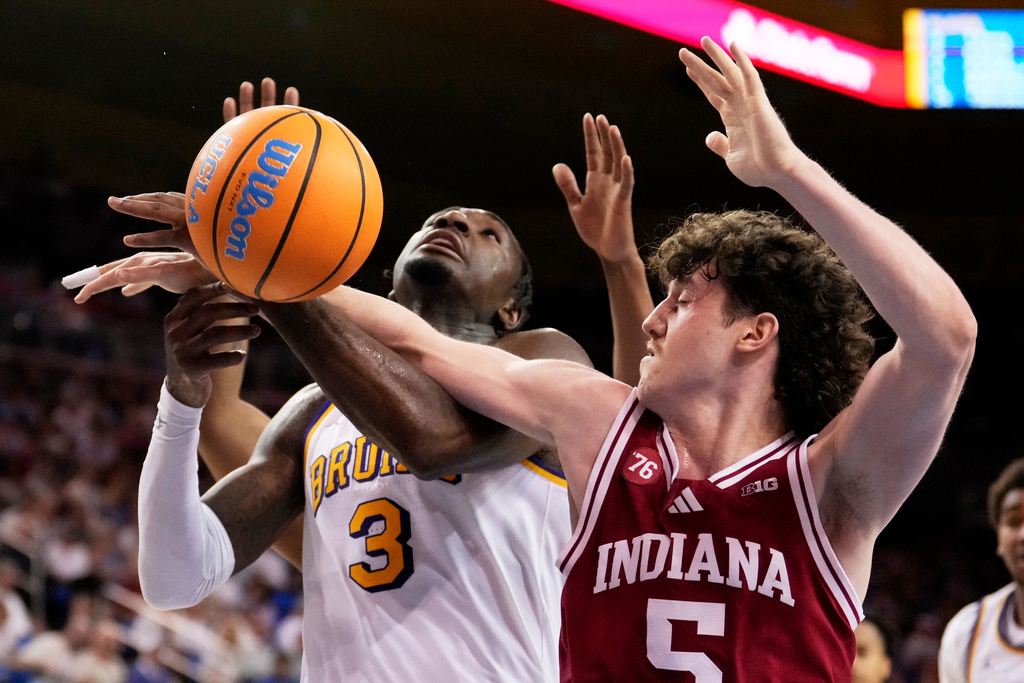 UCLA guard Eric Dailey Jr., left, is founded while shooting by Indiana guard Conor Enright during the second half of an NCAA college basketball game, Saturday, Jan. 31, 2026, in Los Angeles. (AP Photo/Mark J. Terrill)