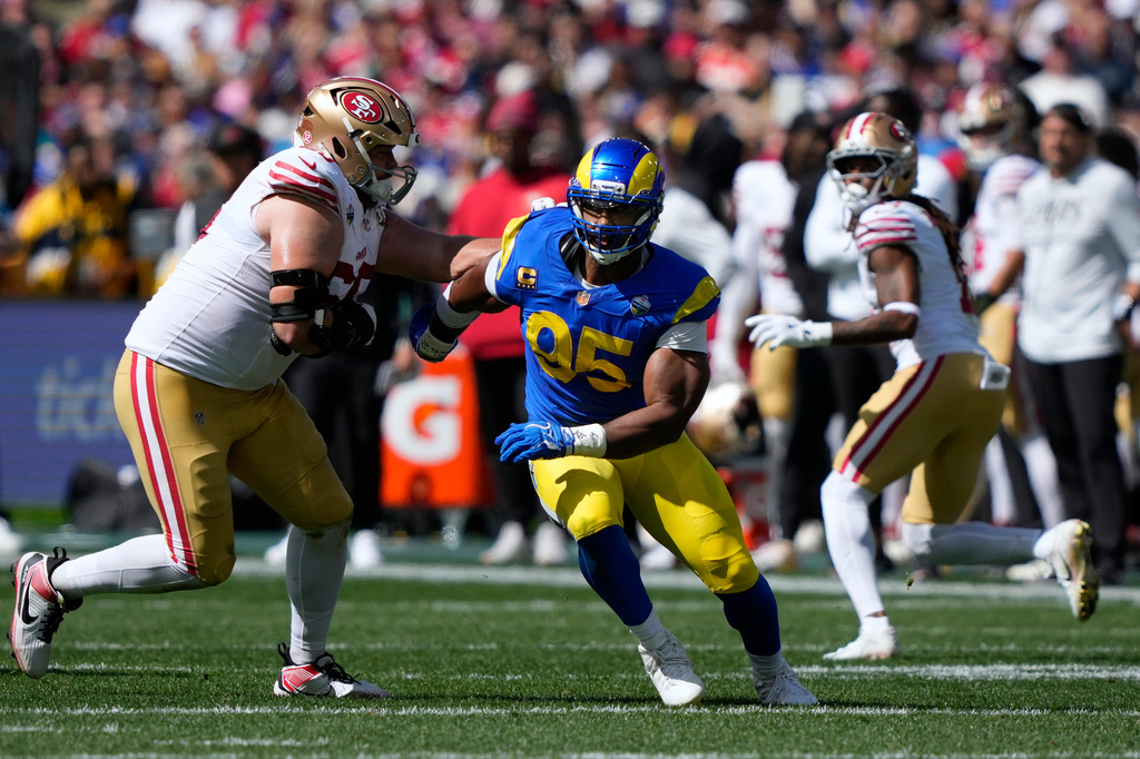 FILE - Los Angeles Rams defensive end Myles Garrett (95) tries to get past San Francisco 49ers offensive tackle Colton McKivitz, left, in the first half of an NFL football game in Melbourne, Australia, on Sept. 11, 2026. (AP Photo/Doug Benc, File)
