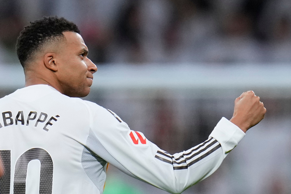 Real Madrid's Kylian Mbappe celebrates after scoring his sides second goal from the penalty spot during the Spanish La Liga soccer match between Real Madrid and Sevilla in Madrid, Spain, Saturday, Dec. 20, 2025. (AP Photo/Manu Fernandez)