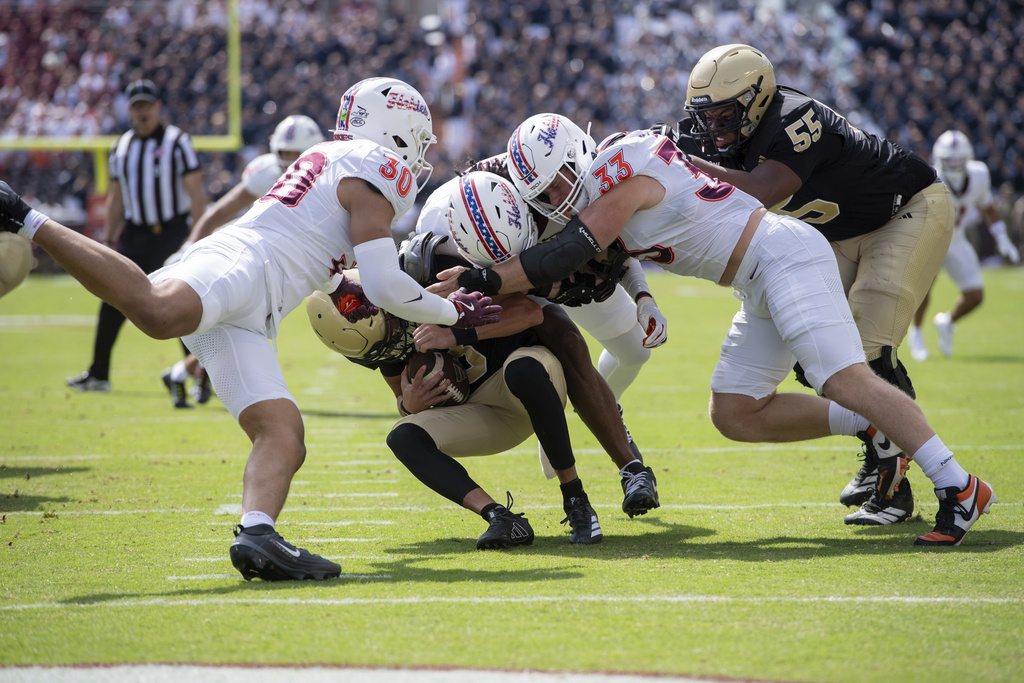 Virginia Tech linebacker Michael Short (30) and defensive lineman Ben Bell (33) sacks Wofford quarterback Jayden Whitaker (8) during the first half of an NCAA college football game Saturday, Sept. 20 2025, in Blacksburg, Va. (AP Photo/Robert Simmons)