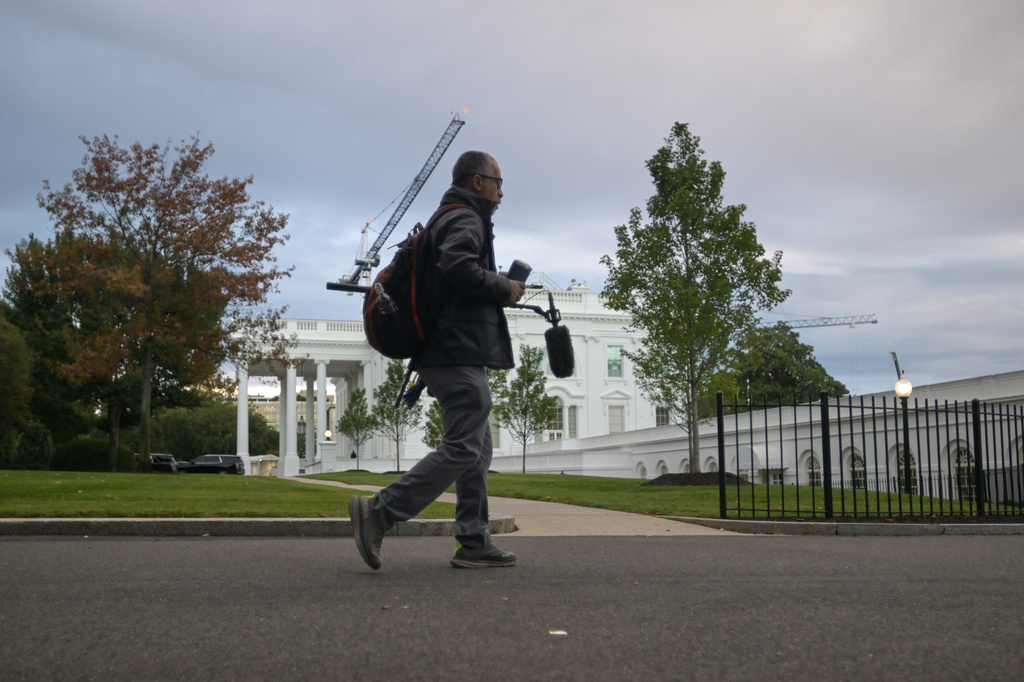A CNN sound technician walks at the White House, Saturday, Sept. 26, 2026, in Washington. (AP Photo/Rod Lamkey, Jr.)