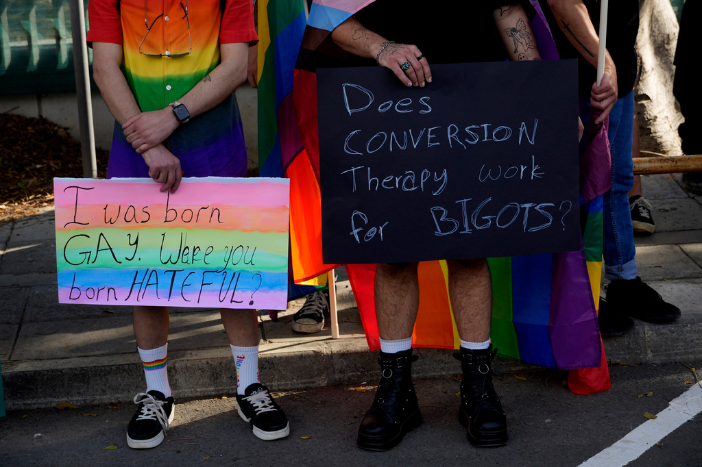 FILE - Demonstrators hold placards during a protest outside from the Parliament house in capital Nicosia, Cyprus, on Thursday, May 25, 2023. (AP Photo/Petros Karadjias, File)