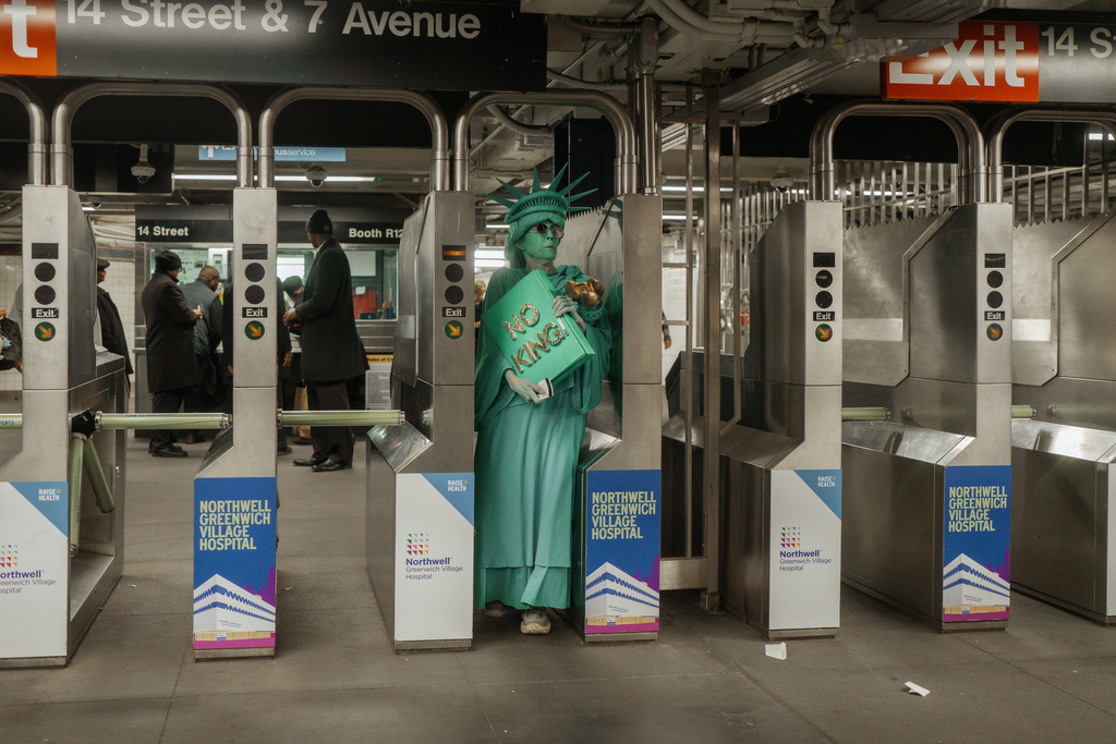 Protester dressed in a Statue of Liberty costume enters the subway station after a "No Kings" protest Saturday, Oct. 18, 2025, in New York. (AP Photo/Olga Fedorova)