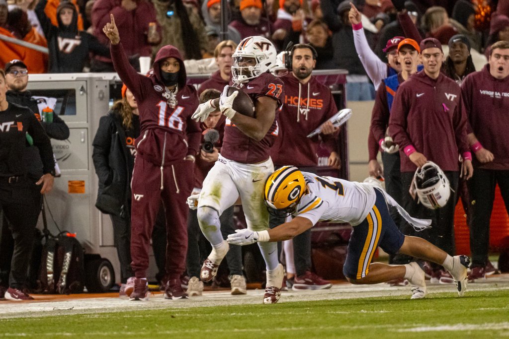 Virginia Tech running back Marcellous Hawkins (27) runs for a first down during an NCAA college football game between California and Virginia Tech, Friday Oct. 24, 2025, in Blacksburg, Va., (AP Photo/Robert Simmons)