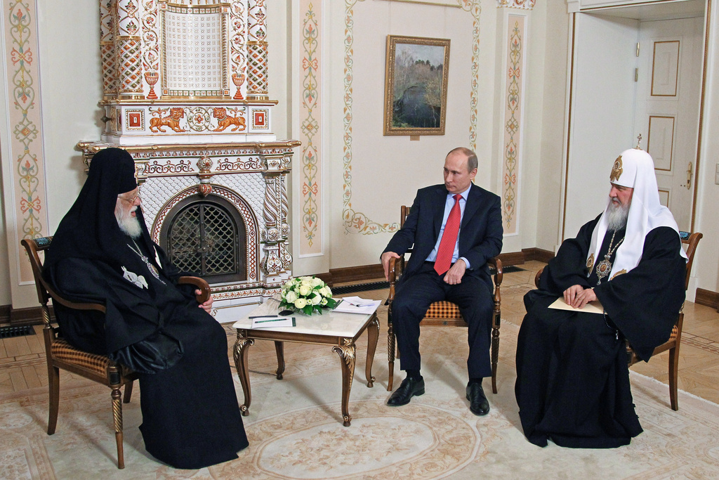 FILE - Russian President Vladimir Putin, center, meets with Georgian Orthodox Patriarch Ilia II, left, and Russian Orthodox Patriarch Kirill at the Novo-Ogaryovo residence outside Moscow, Wednesday, Jan. 23, 2013. (Mikhail Klimentyev/Sputnik, Kremlin Pool Photo via AP, File)