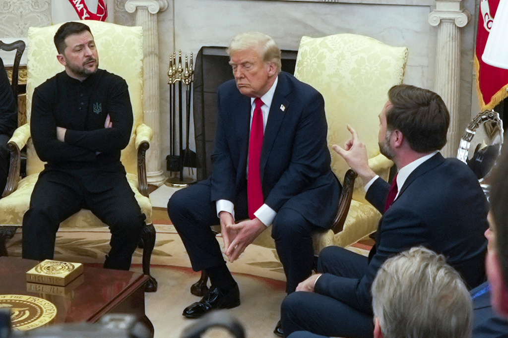 FILE - Vice President JD Vance, right, speaks with Ukrainian President Volodymyr Zelenskyy as President Donald Trump listens in the Oval Office at the White House in Washington, Feb. 28, 2025. (AP Photo/ Mystyslav Chernov, File)
