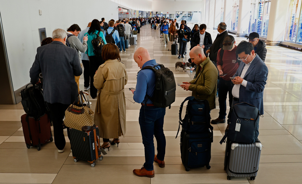 Passengers stand in the TSA pre check in line at LaGuardia Airport, Thursday, March 26, 2026, in East Elmhurst, N.Y. (AP Photo/Noah K. Murray)