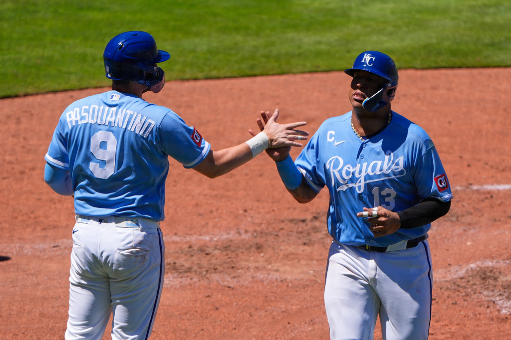 Kansas City Royals' Salvador Perez (13) celebrates with Vinnie Pasquantino (9) after they both scored on a two-run double hit by Carter Jensen during the fifth inning of a baseball game against the Seattle Mariners, Sunday, May 24, 2026, in Kansas City, Mo. (AP Photo/Charlie Riedel)