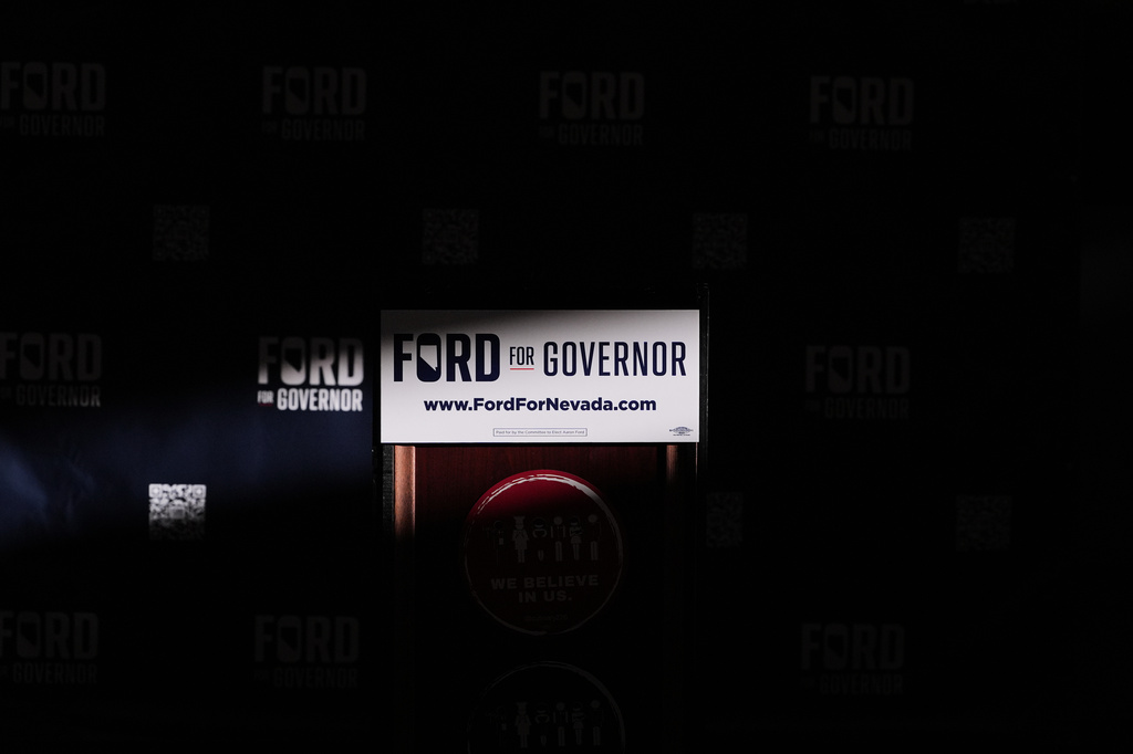 Light illuminates the podium for Gubernatorial candidate Aaron Ford, attorney general of Nevada, during a primary election night watch party Tuesday, June 9, 2026, in Las Vegas. (AP Photo/Jae C. Hong)