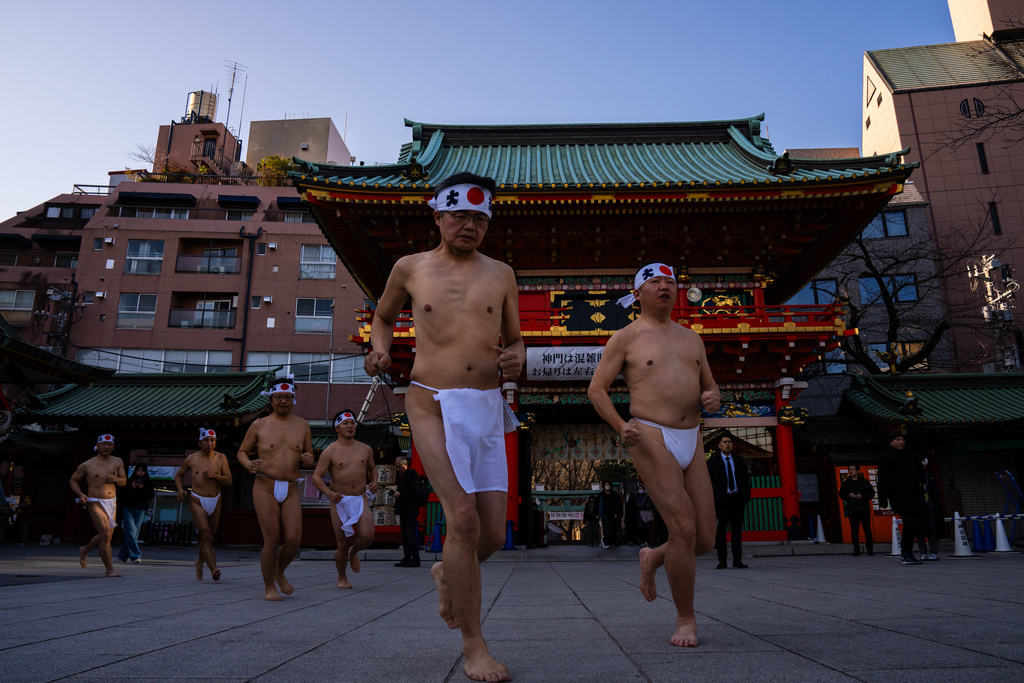 Participants prepare to bathe in ice-cold water to purify their souls and pray for good health during a New Year's ritual at Kanda Myojin Shrine in Tokyo, Saturday, Jan. 17, 2026. (AP Photo/Louise Delmotte)