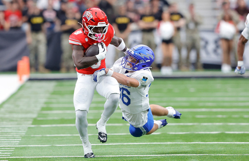 UNLV running back Jai'Den Thomas (9) is tackled by Air Force defensive back Max Mustell (36) during the first half of an NCAA football game Saturday, Oct. 11, 2025, in Las Vegas. (Steve Marcus/Las Vegas Sun via AP) UNLV running back Jai'Den Thomas (9) is tackled by Air Force defensive back Max Mustell (36) during the first half of an NCAA football game Saturday, Oct. 11, 2025, in Las Vegas. (Steve Marcus/Las Vegas Sun via AP)