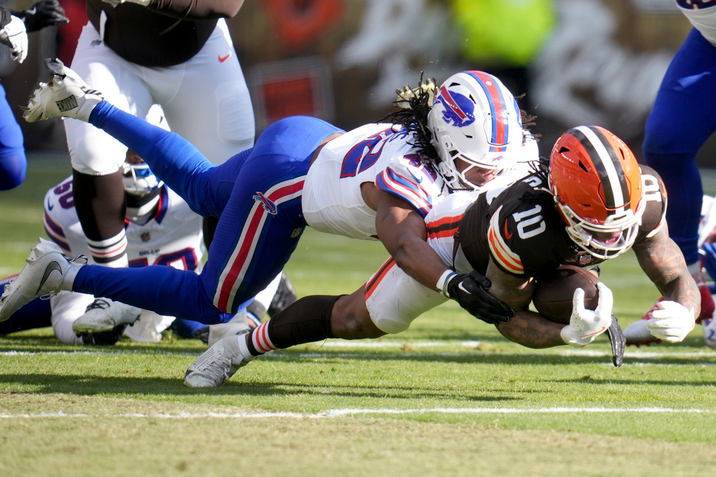 Cleveland Browns running back Quinshon Judkins (10) is tackled by Buffalo Bills linebacker Dorian Williams (42) during the first half of an NFL football game in Cleveland, Sunday, Dec. 21, 2025. (AP Photo/Sue Ogrocki)