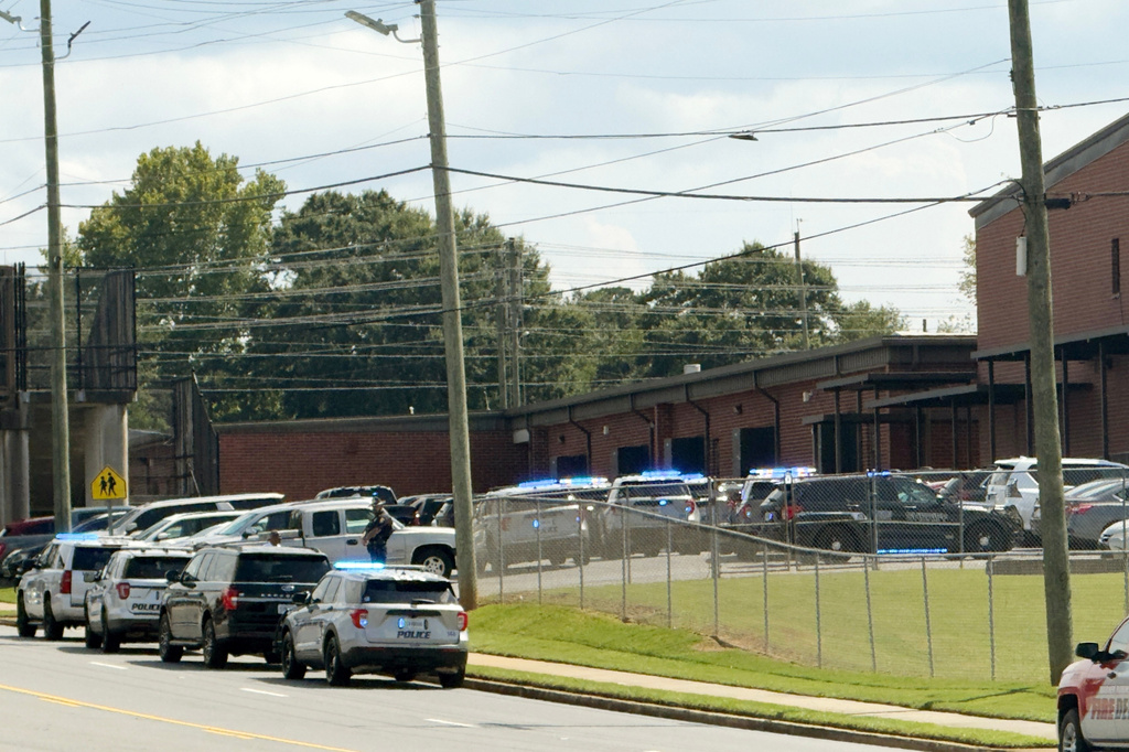Law enforcement responds to a school shooting at Warner Robins High School, Wednesday, Aug. 12, 2026, in Warner Robins, Ga. (Joe Kovac/Atlanta Journal-Constitution via AP)