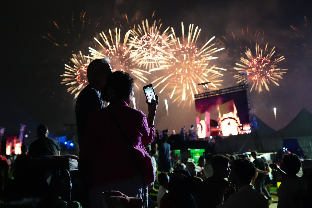 People watch fireworks at Salute to America, an Independence Day event honoring the nation's 250th anniversary, early Sunday, July 5, 2026, on the National Mall in Washington. (AP Photo/Julia Demaree Nikhinson)