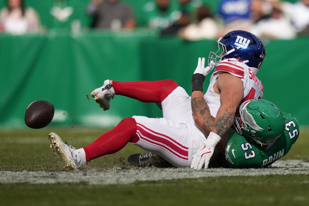 New York Giants running back Cam Skattebo (44) is injured near Philadelphia Eagles linebacker Zack Baun (53) during the first half of an NFL football game Sunday, Oct. 26, 2025, in Philadelphia. (AP Photo/Matt Slocum)