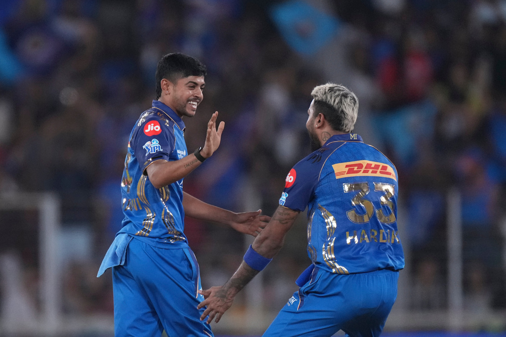 Mumbai Indians' Ashwani Kumar, left, and Mumbai Indians' captain Hardik Pandya celebrates the wicket of Gujarat Titans' captain Shubman Gill during the Indian Premier League cricket match between Gujarat Titans and Mumbai Indians in Ahmedabad, India, Monday, April 20, 2026.(AP Photo/ Ajit Solanki )