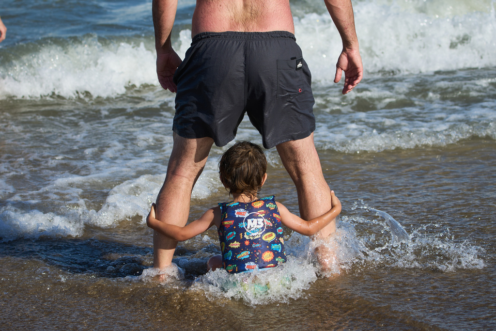 FILE - People spend time on the beach in Carilo, Buenos Aires province, Argentina, Dec. 28, 2025. (AP Photo/Rodrigo Abd, File)